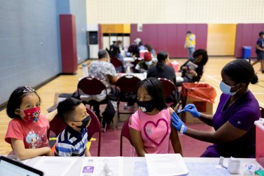 FILE PHOTO: Adolescents receive COVID-19 vaccine