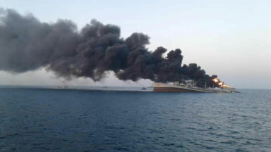 Smoke rises from Iran navy’s largest ship in Jask port in the Gulf