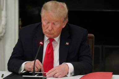 FILE PHOTO: U.S. President Trump uses phone during roundtable discussion on the reopening of U.S. economy at the White House in Washington