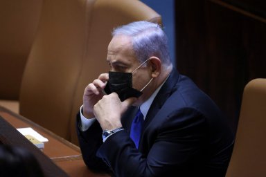 Israeli Prime Minister Netanyahu speaks on his mobile phone during a special session of the Knesset whereby Israeli lawmakers elect a new president, at the plenum in the Knesset, Israel’s parliament, in Jerusalem