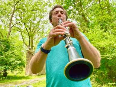 FILE PHOTO: David Rothenberg, a professor of philosophy and music at the New Jersey Institute of Technology, plays the clarinet along with the sounds of cicadas