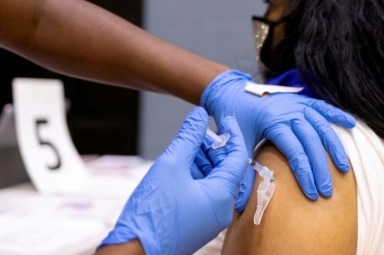 FILE PHOTO: A woman receives a COVID-19 vaccine at a clinic in Philadelphia