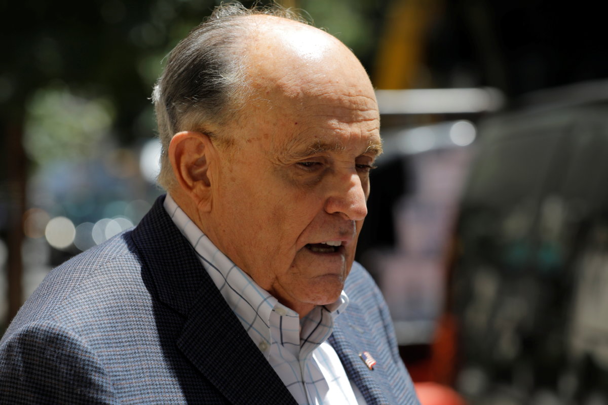 Former New York City Mayor Rudy Giuliani speaks to media outside his apartment building after suspension of his law license in Manhattan in New York City