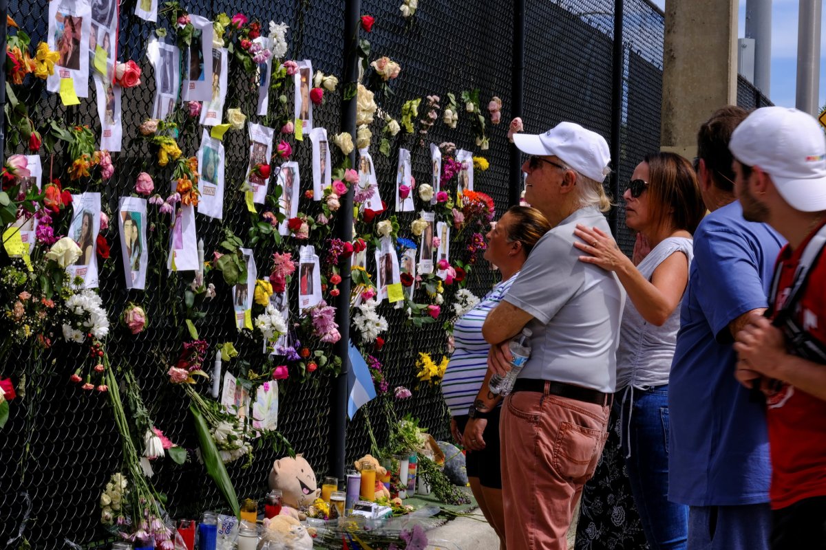 A memorial site created by neighbors in front of Champlain Towers South, in Surfside