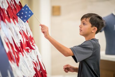 Boy-with-ribbon-flag.-Credit-MoAR