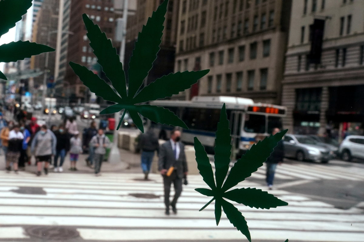 FILE PHOTO: Cannabis stickers on a Weed World store window are pictured the day New York State legalized recreational marijuana use in New York City