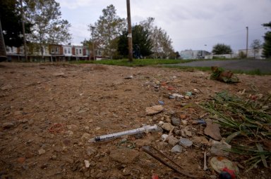 FILE PHOTO: A needle used for shooting heroin litters the ground in a park in the Kensington section of Philadelphia