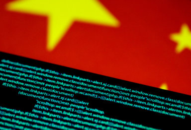 FILE PHOTO: Illustration photo of computer code on a screen above a Chinese flag