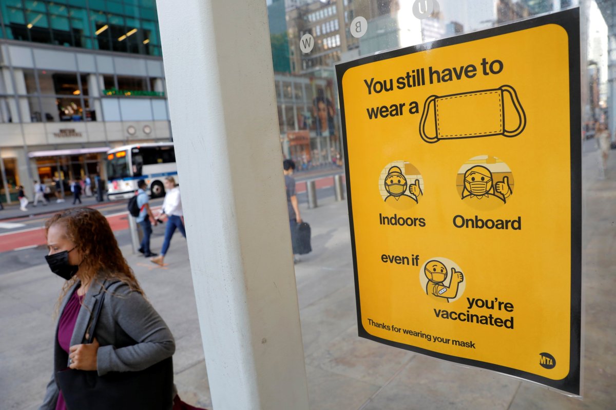 A poster alerting for the wearing of masks is seen on a 42nd Street subway entrance as cases of the infectious coronavirus Delta variant continue to rise in New York City