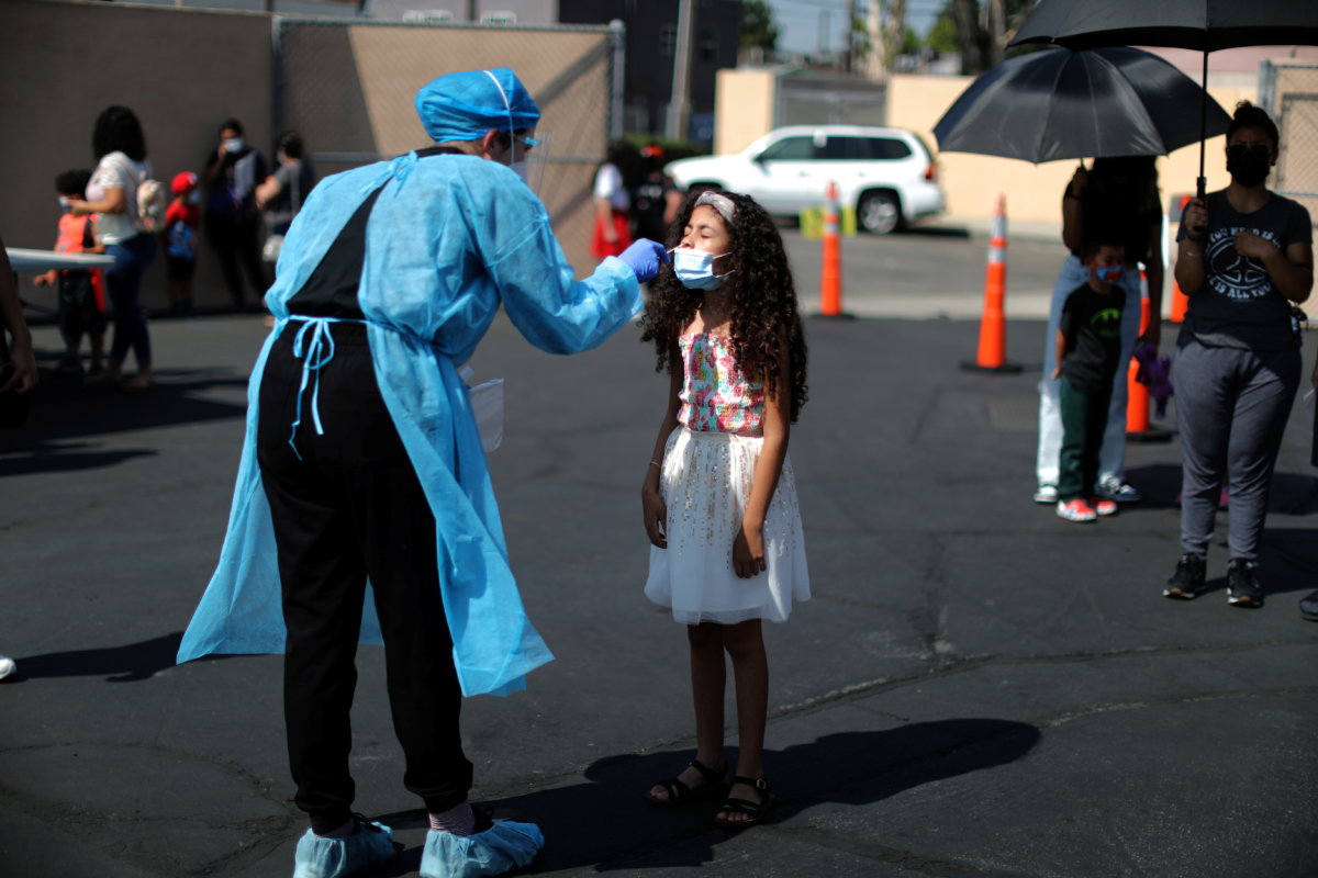 Alisson Argueta, 8, is given a COVID-19 test at a back-to-school clinic in Los Angeles