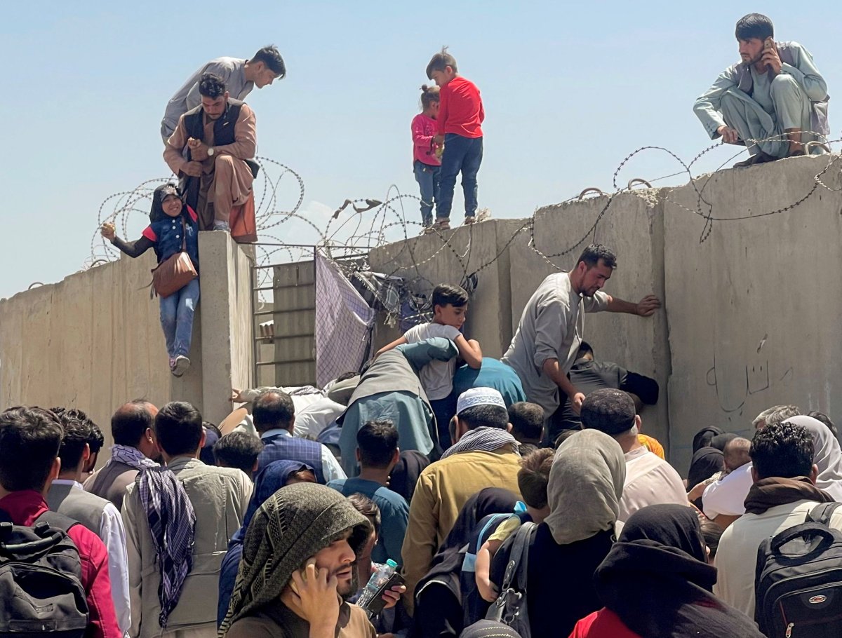 A man pulls a girl to get inside Hamid Karzai International Airport in Kabul