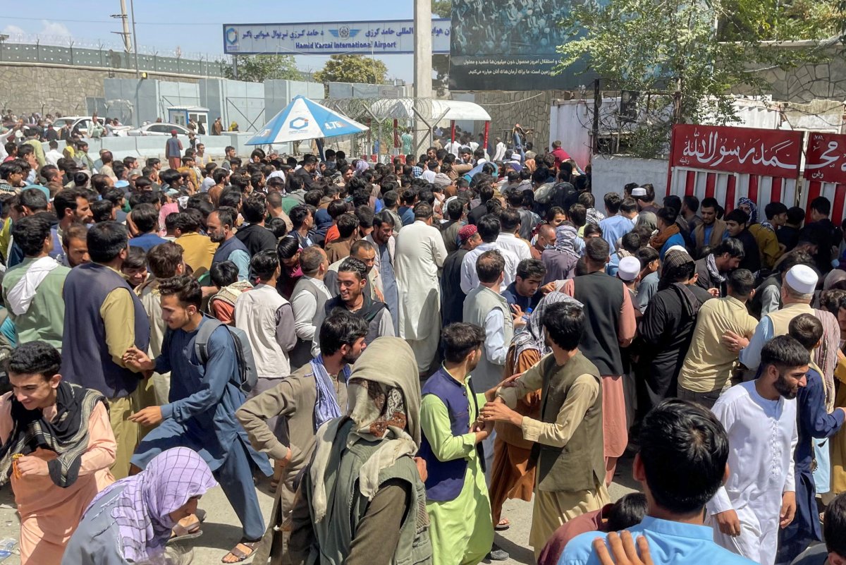 People try to get into Hamid Karzai International Airport in Kabul