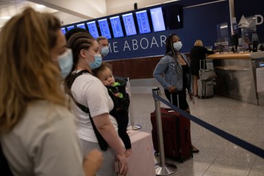 Passengers gather at a Delta airline’s counter as they check-in their luggage, at Hartsfield-Jackson Atlanta International Airport, in Atlanta