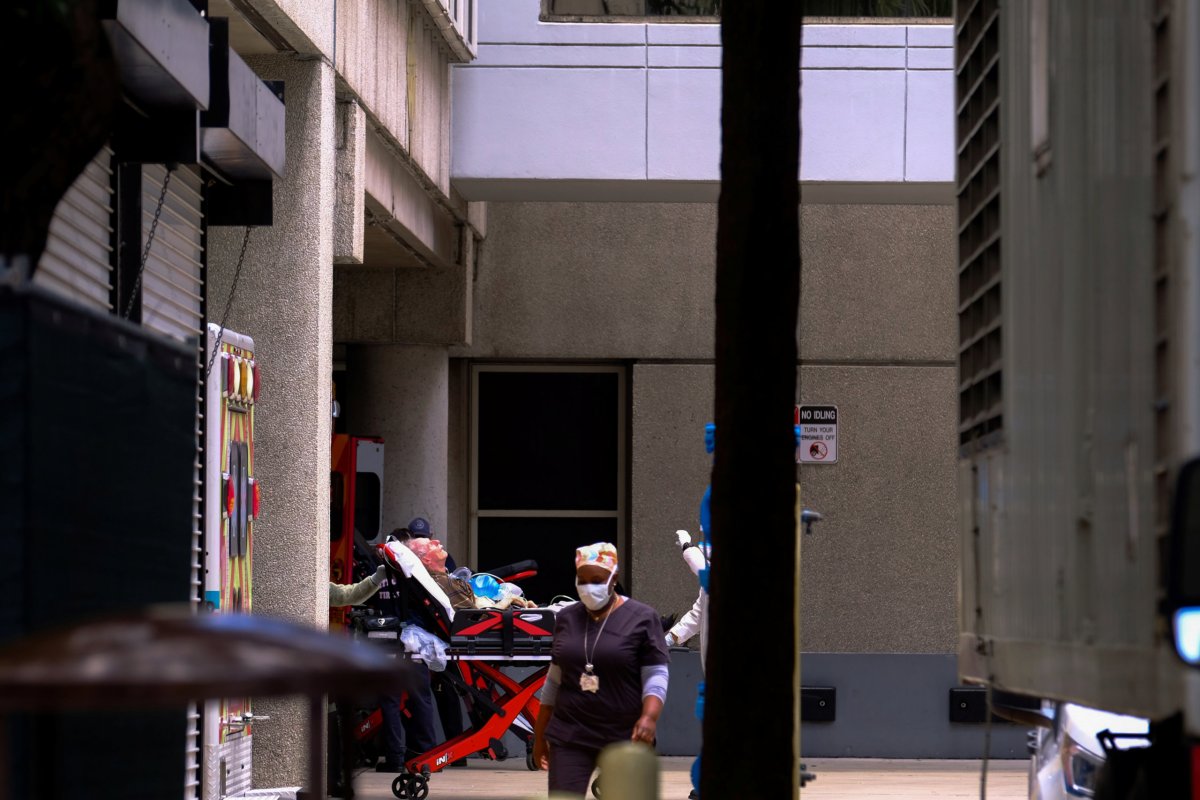 Emergency Medical Technicians (EMT) arrive with a patient to Jackson Health Center, where the coronavirus disease (COVID-19) patients are treated, in Miami