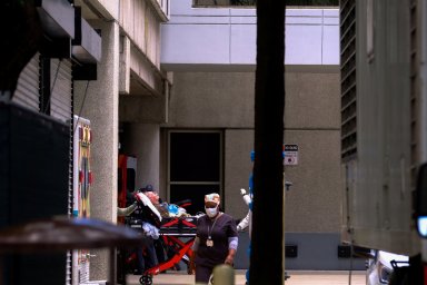 Emergency Medical Technicians (EMT) arrive with a patient to Jackson Health Center, where the coronavirus disease (COVID-19) patients are treated, in Miami