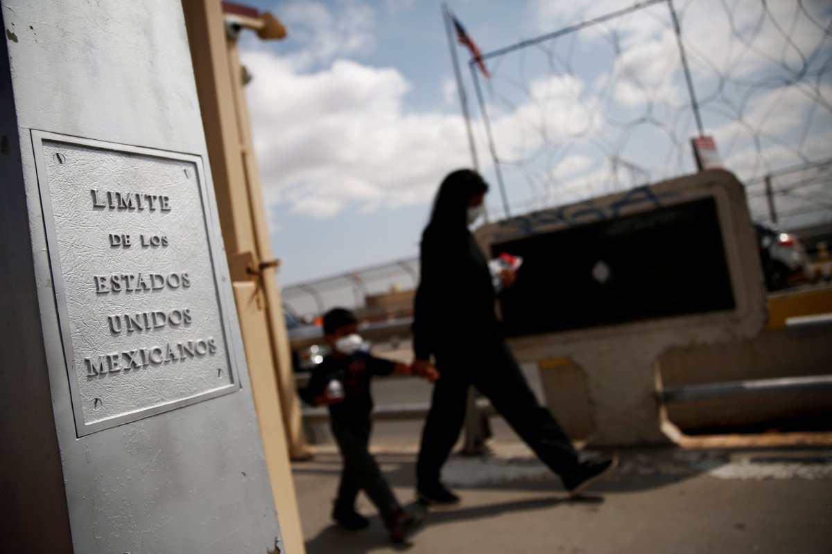 FILE PHOTO: Central American migrants expelled from the U.S. under Title 42 walk towards Mexico on the Lerdo Stanton International Bridge, as seen from Ciudad Juarez