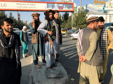 A member of Taliban stands outside Hamid Karzai International Airport in Kabul