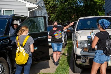 Karla Conrad and Denver Foote, canvassers with Iowa Citizens for Community Improvement, knock on doors to register people to vote in upcoming local elections in Des Moines, Iowa