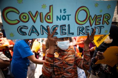 A woman takes part in a protest to get rent relief or rent freeze outside a Marshall office in the borough of Manhattan, in New York