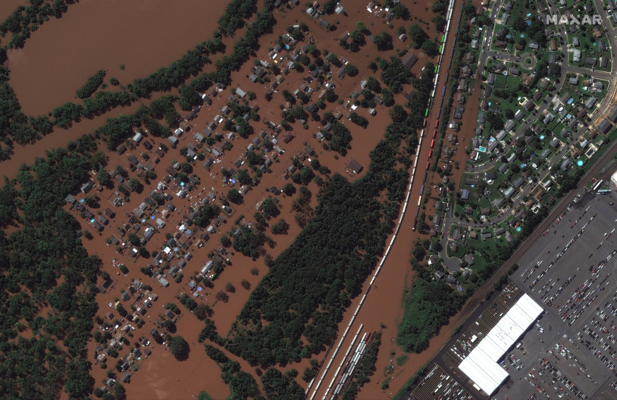 A satellite image shows a rail yard and homes along Huff Avenue submerged in floodwater after torrential rains swept through Manville, New Jersey