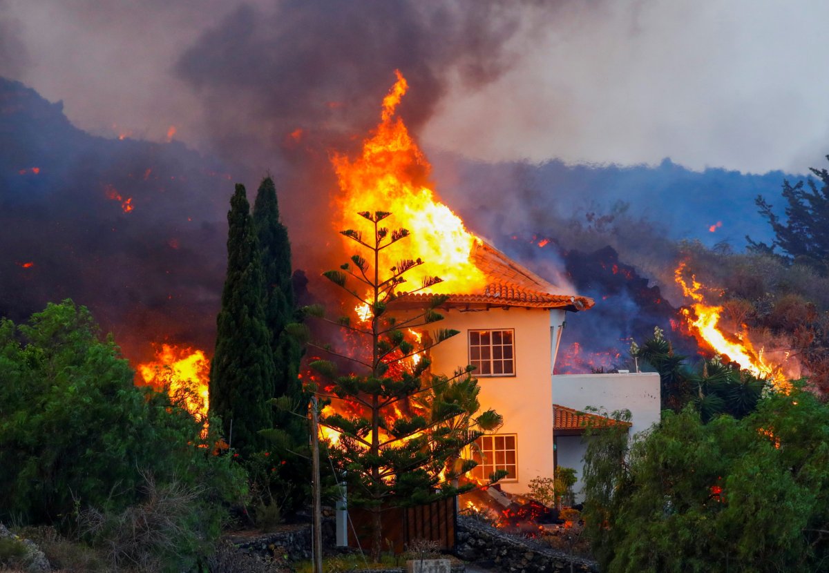 A house burns due to lava from the eruption of a volcano in Spain