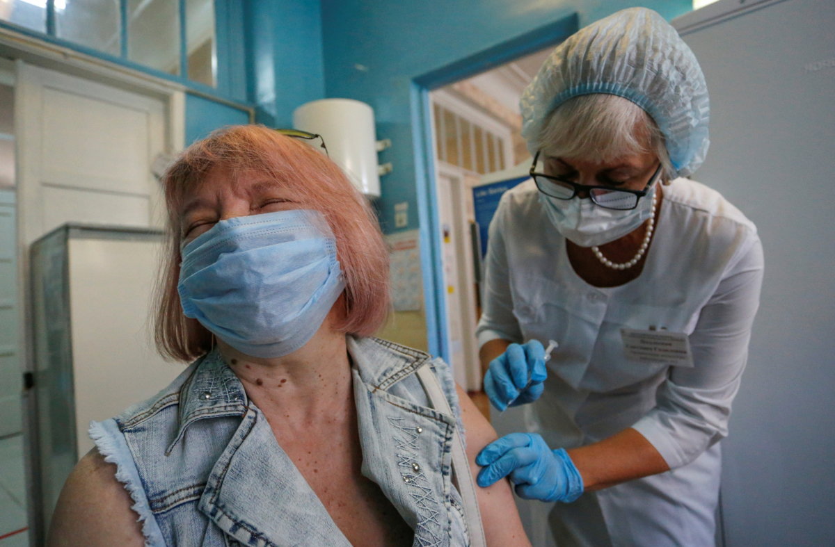 A woman is injected with Sputnik Light vaccine against the coronavirus disease  in Donetsk