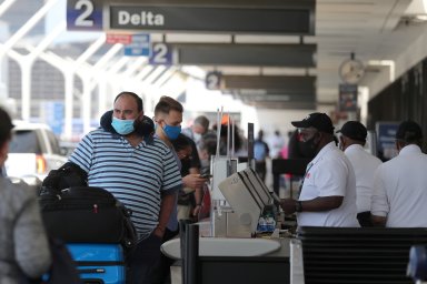 FILE PHOTO: Passengers queue at LAX airport before Memorial Day weekend in Los Angeles