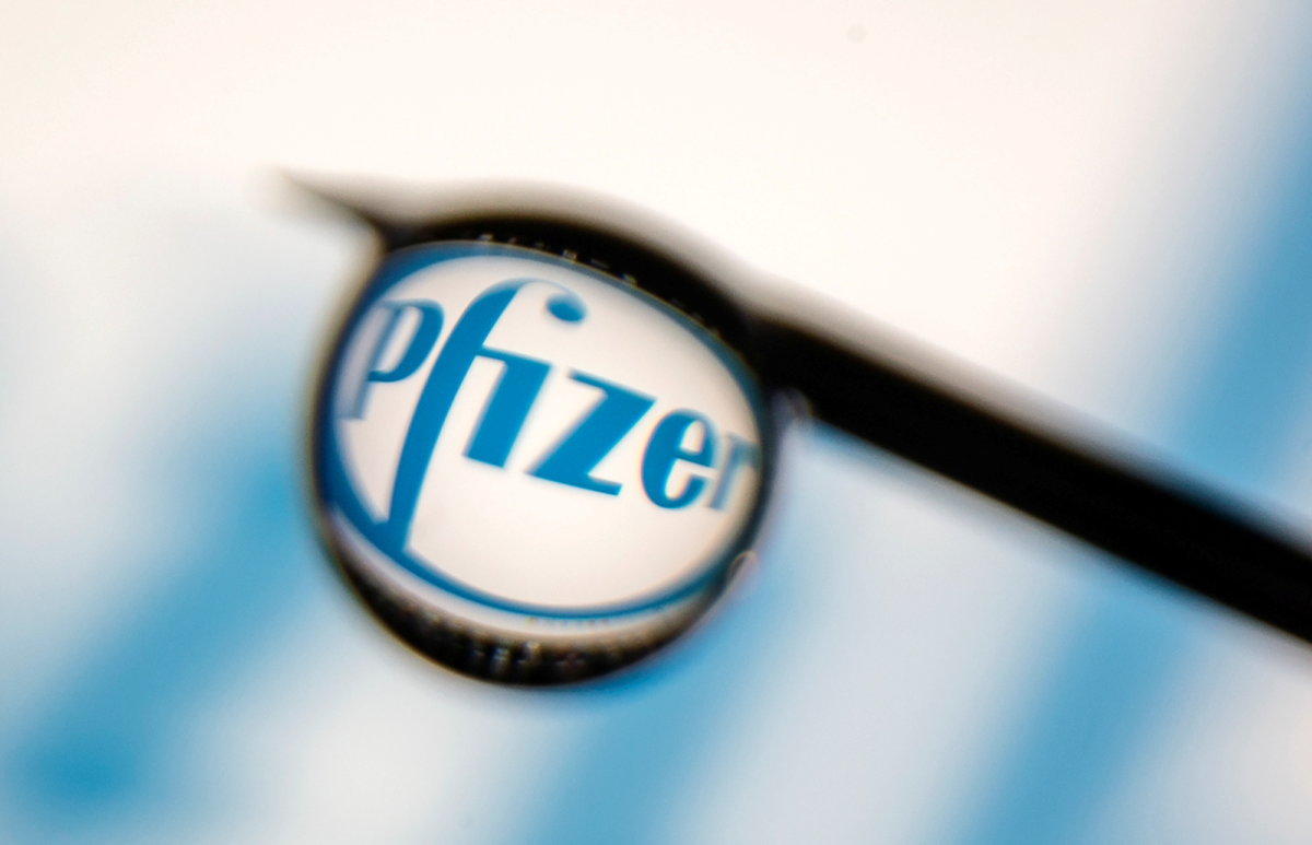 FILE PHOTO: Pfizer logo is reflected in a drop on a syringe needle in this illustration photo