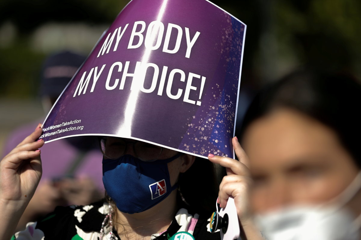 FILE PHOTO: A demonstrator holds a pro-abortion rights sign as she listens to speakers at a Black Women Take Action event outside the U.S. Supreme Court building in Washington