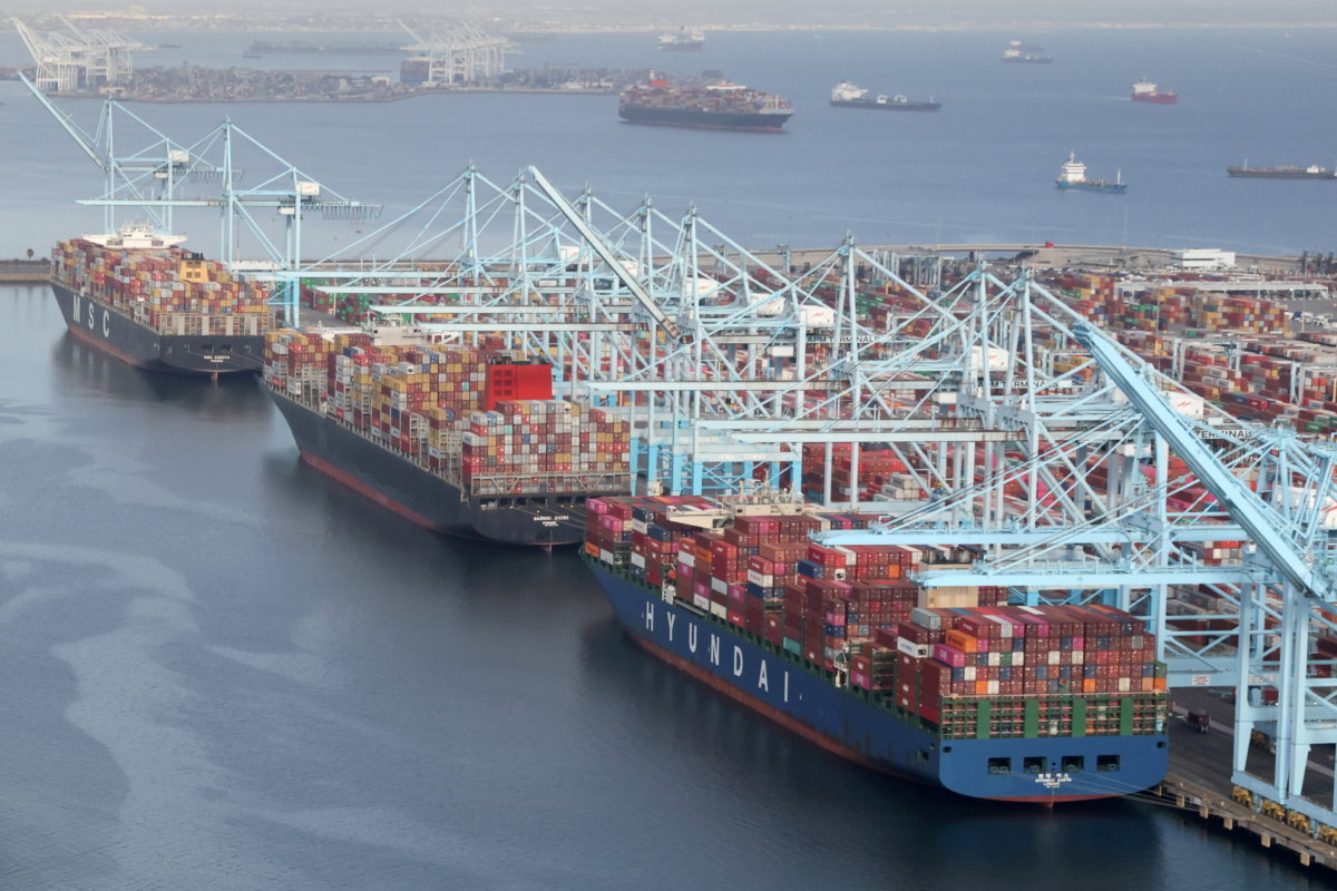 FILE PHOTO: FILE PHOTO: Shipping containers are unloaded from ships at a container terminal at the Port of Long Beach-Port of Los Angeles complex in Los Angeles