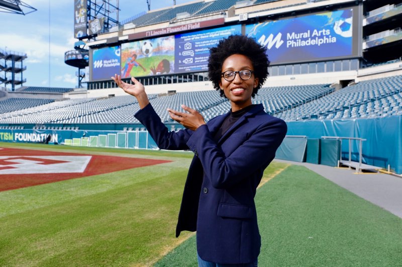 Nile Livingston (Artist) & World Cup Bid Mural (Courtesy of Jeff Fusco)