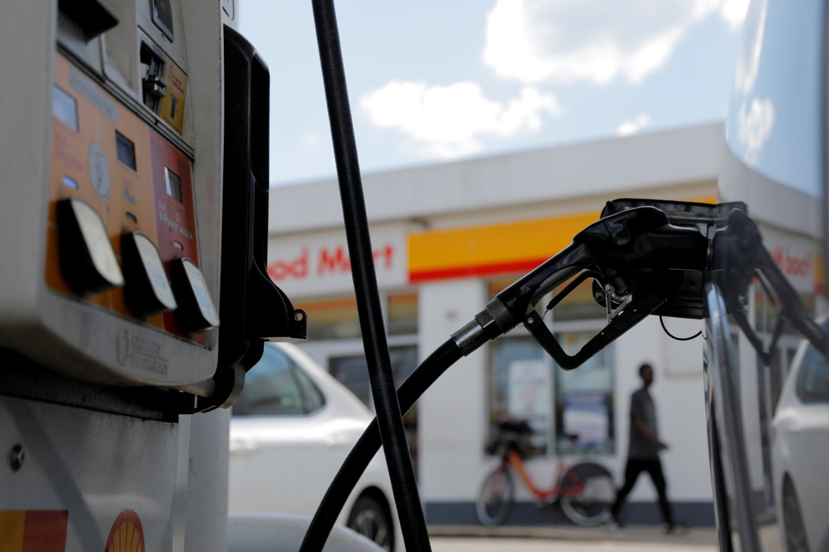 FILE PHOTO: A gas pump is seen in a car at a Shell gas station in Washington, D.C.