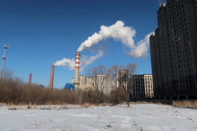 FILE PHOTO: A coal-fired heating complex is seen behind the ground covered by snow in Harbin