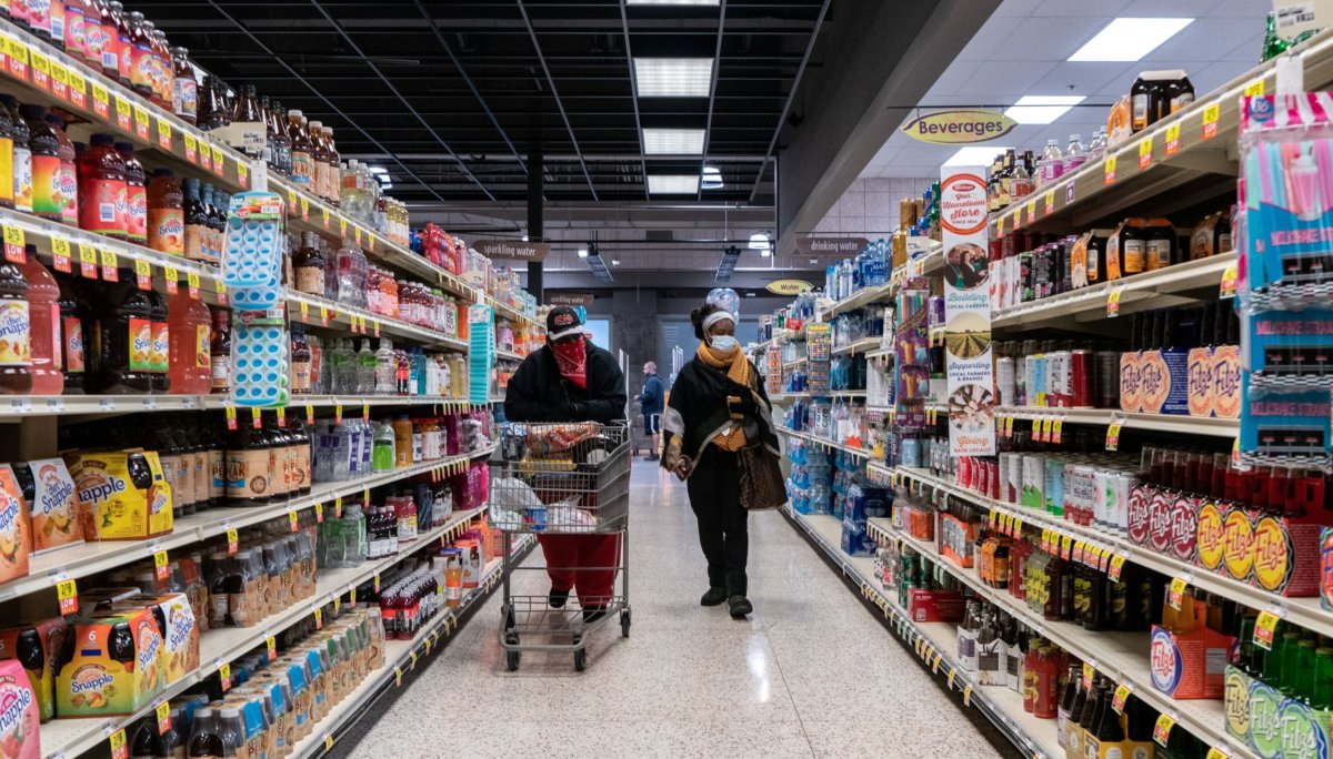 FILE PHOTO: Shoppers browse in a supermarket while wearing masks in St Louis