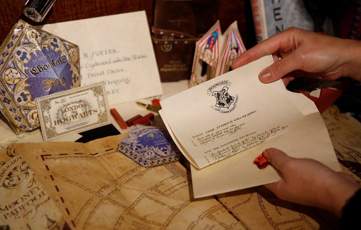 Artist Miraphora Mina places actual props that she created with Eduardo Lima for the movie Harry Potter and the Philosopher’s Stone, into a display cabinet at their store in London