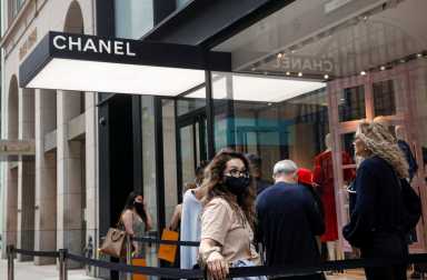 FILE PHOTO: Shoppers wait in line to enter the Chanel store on 57th St in New York
