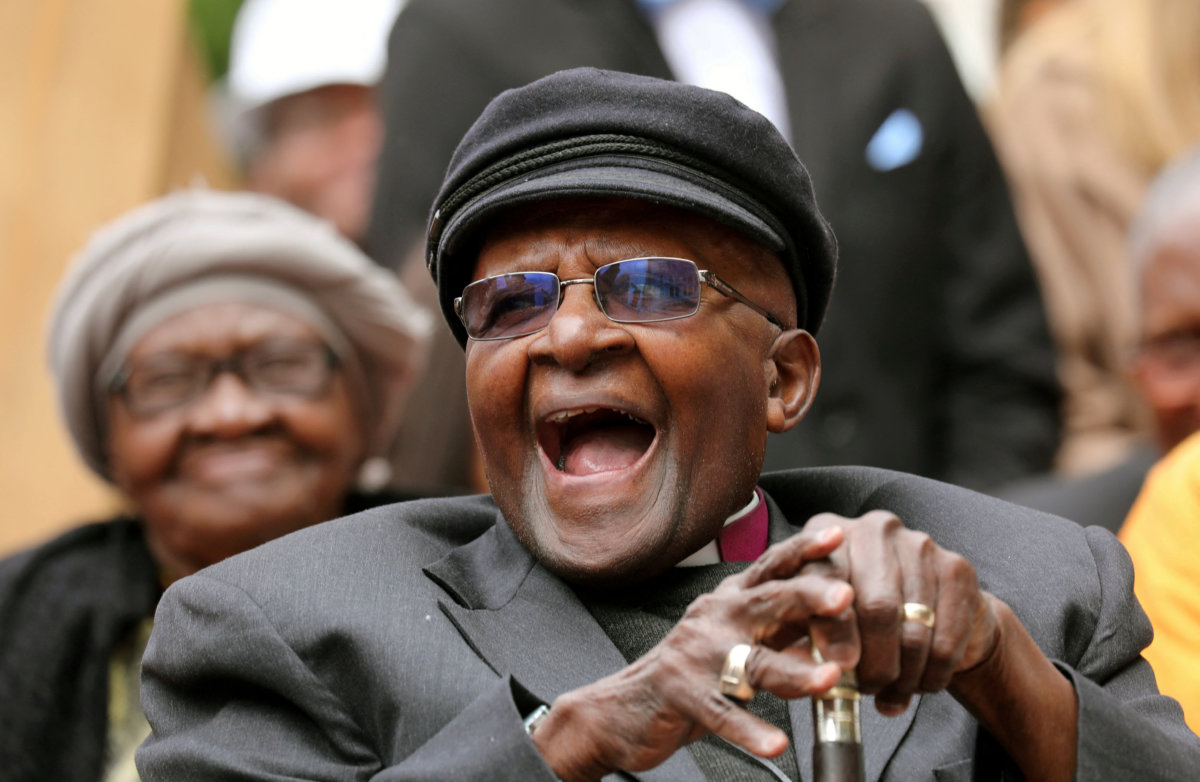 Archbishop Desmond Tutu laughs as crowds gather to celebrate his bithday by unveiling an arch in his hounour outside St Georges Cathedral in Cape Town