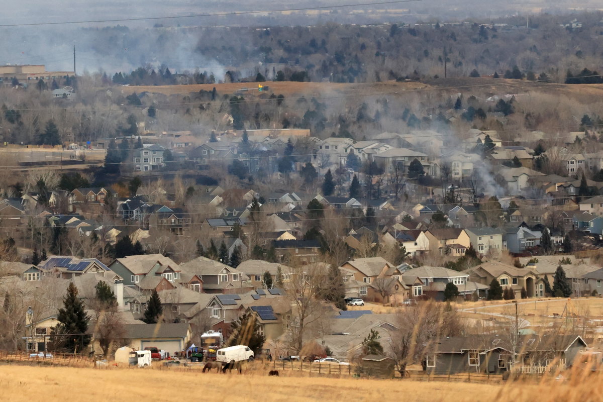 FILE PHOTO: Smoke rises a day after wind-driven wildfires prompted evacuation orders in Superior