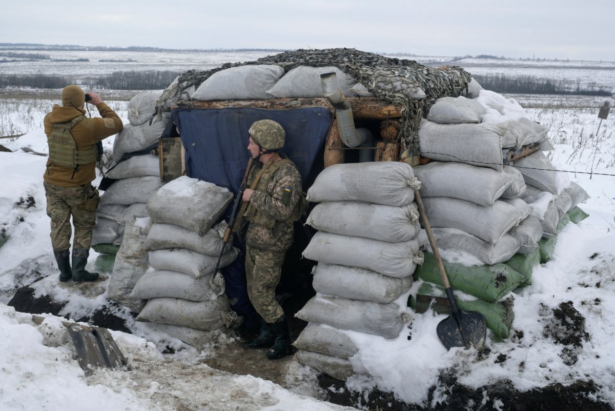 Service members of the Ukrainian armed forces stand guard at combat positions in the Luhansk region