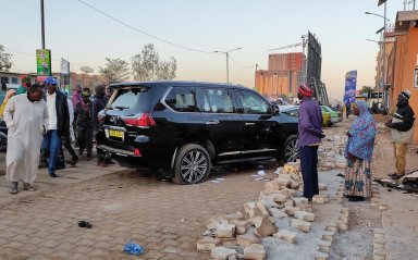 Bullet holes are seen in a car that belong to presidency  following heavy gunfire near the president Roch Kabore residence  in Ouagadougou