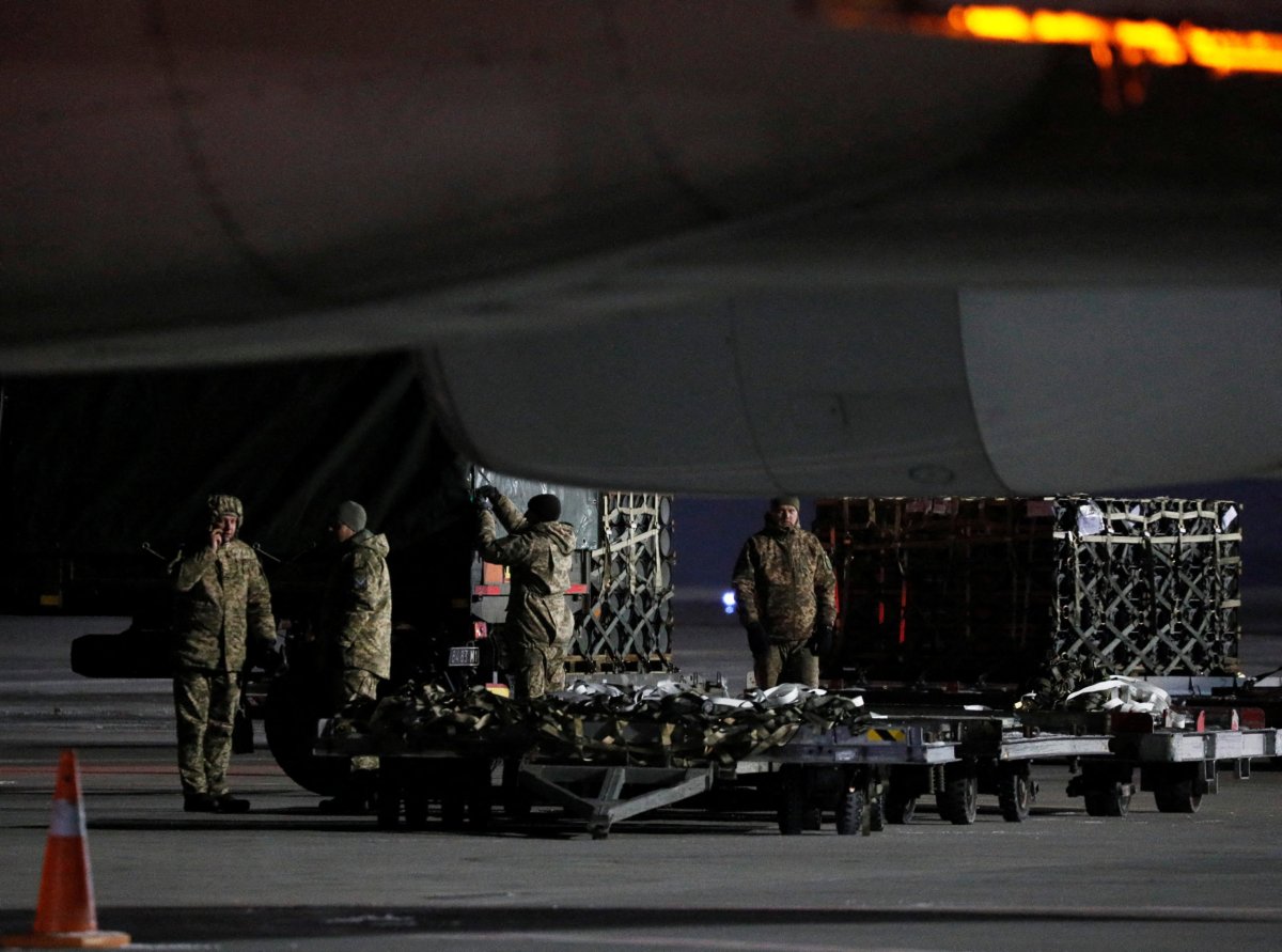 Ukrainian service members unload a shipment of military aid from the United States of America, at the Boryspil International Airport