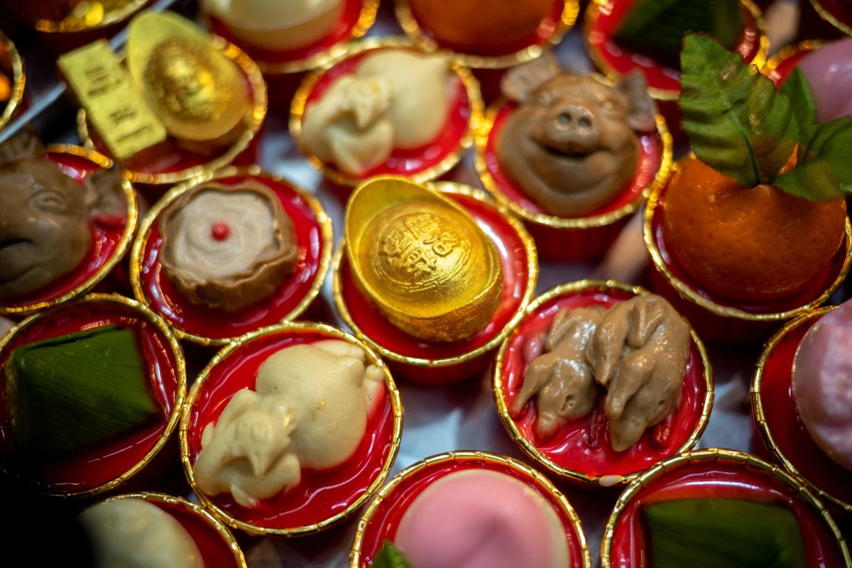 Coconut milk jelly dessert cups in various shapes are displayed ahead of the Chinese new year at Namjai dessert shop in Bangkok