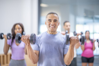 Senior male at group fitness class