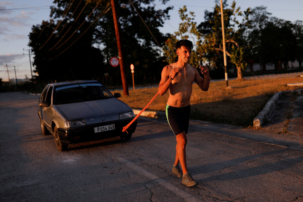 FILE PHOTO: Young Cuban Emanuel Castellano, seeks to break record by pulling car with shoulder blades, in Sancti Spiritus