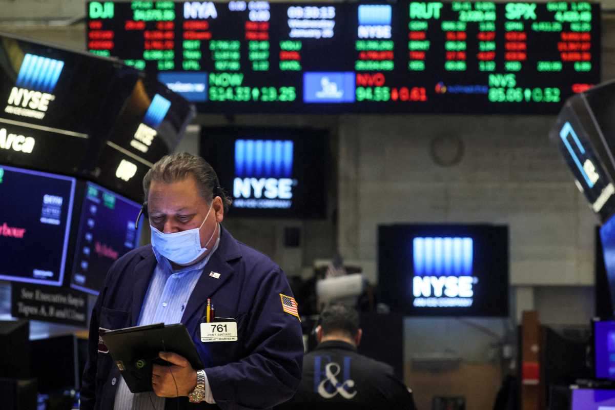FILE PHOTO: Traders work on the floor of the NYSE in New York