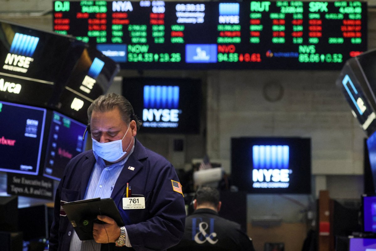 FILE PHOTO: Traders work on the floor of the NYSE in New York