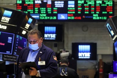 FILE PHOTO: Traders work on the floor of the NYSE in New York