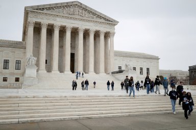 FILE PHOTO: Visitors walk along Supreme Court Plaza on Capitol Hill in Washington