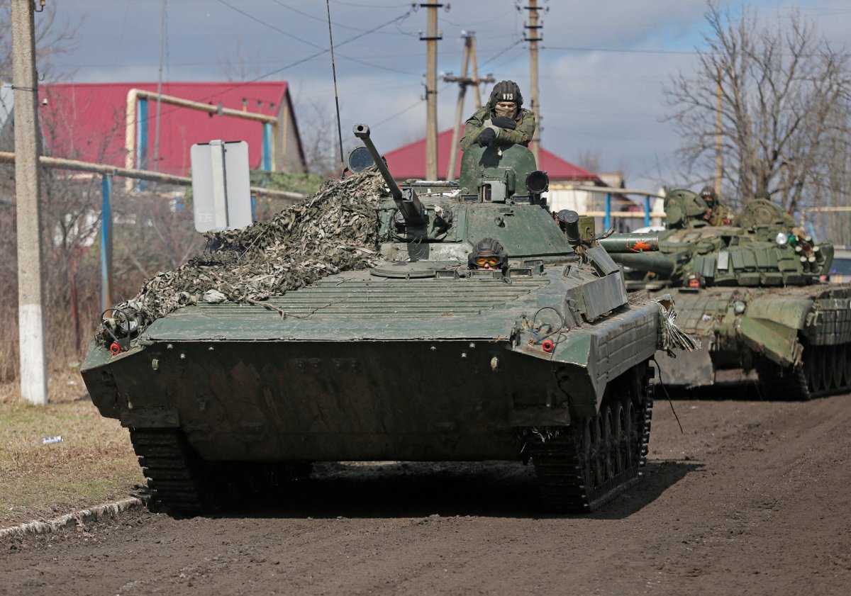 Service members of pro-Russian troops in uniforms without insignia drive an armoured vehicle in the Donetsk region