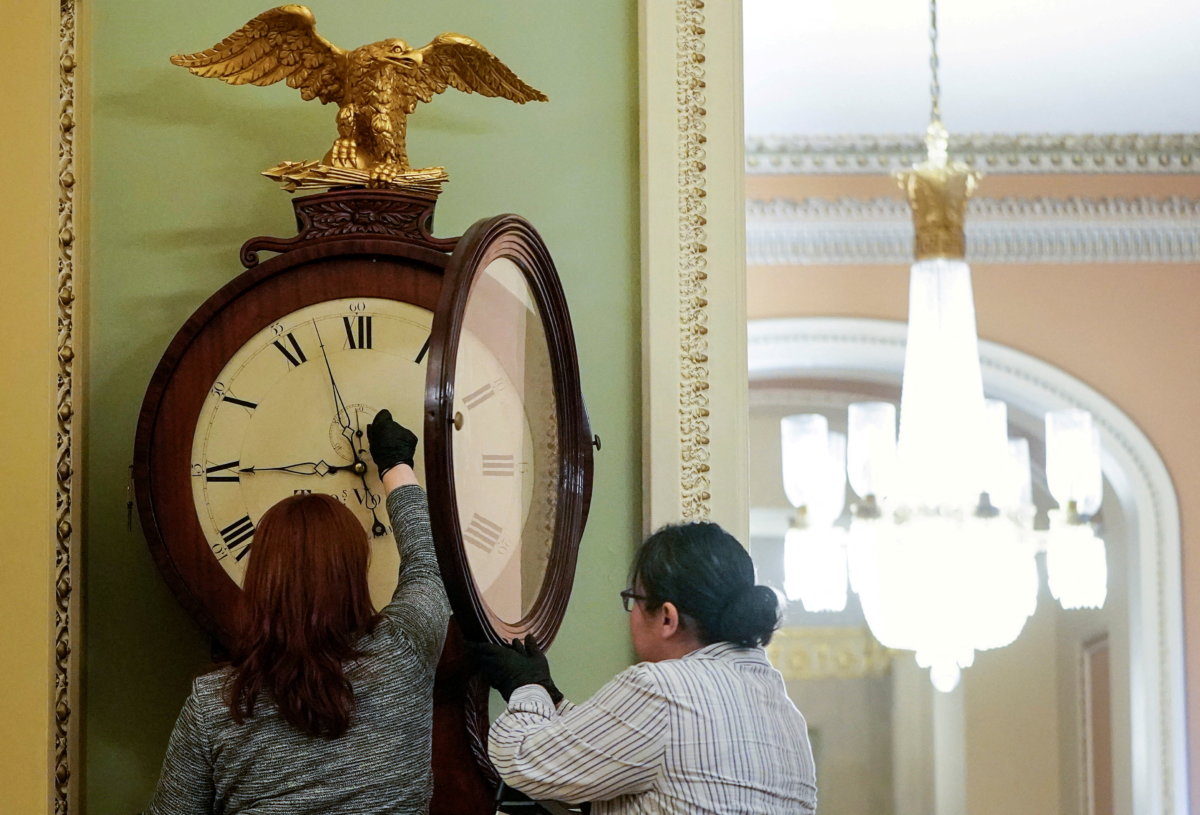 FILE PHOTO: Architect of the Capitol workers wind Ohio Clock in Washington